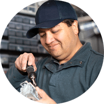 a maintenance man holding a screwdriver and fixing something